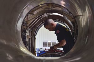 Machinist’s Mate 1st Class Chris Enlow performs routine maintenance on a Blue Angels’ jet engine